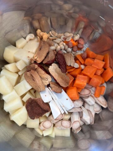 Ingredients to make burdock root soup in the inner pot of an Instant Pot.