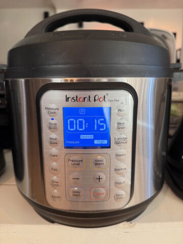 An closed Instant Pot set to the "Soup" setting for 15 minutes on high pressure.