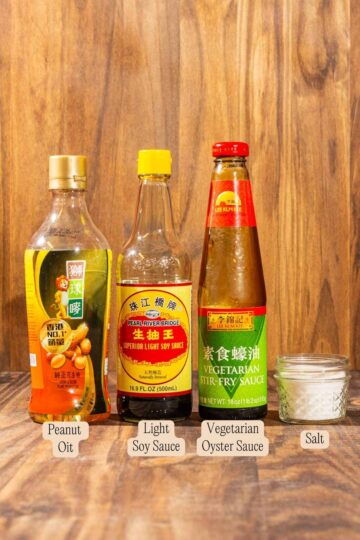Condiments required to make Chinese Garlic Chives Bean Curd Stir Fry, on a wooden surface and labeled.