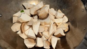 King oyster mushroom chunks cooking in a wok.